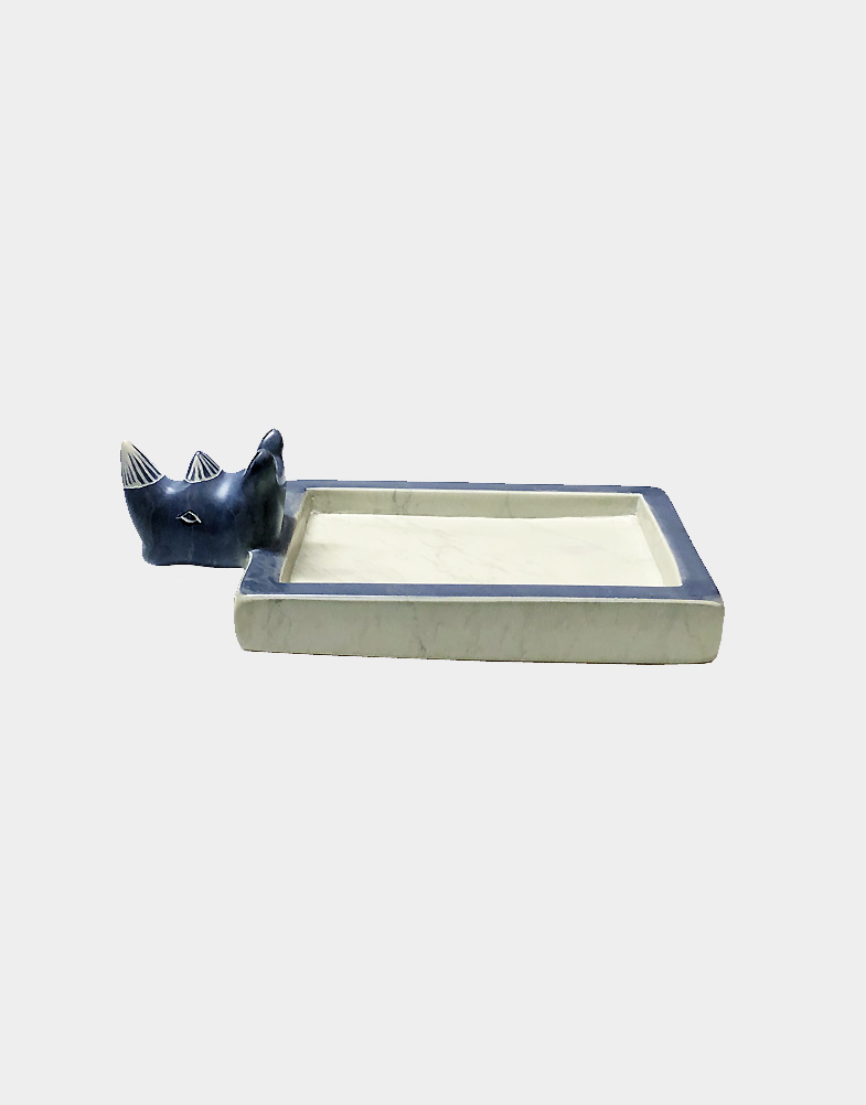 This soap dish is hand carved from a single piece of soapstone and features a rhino's head as the main design element. Muted blue dye added contrast. Free shipping