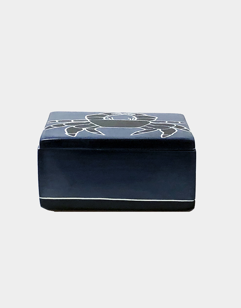 Kenyan artisans hand carve soapstone then add a somber slate blue dyed finish. A bold black crab with etched details completes the design. Free shipping!! Buy now