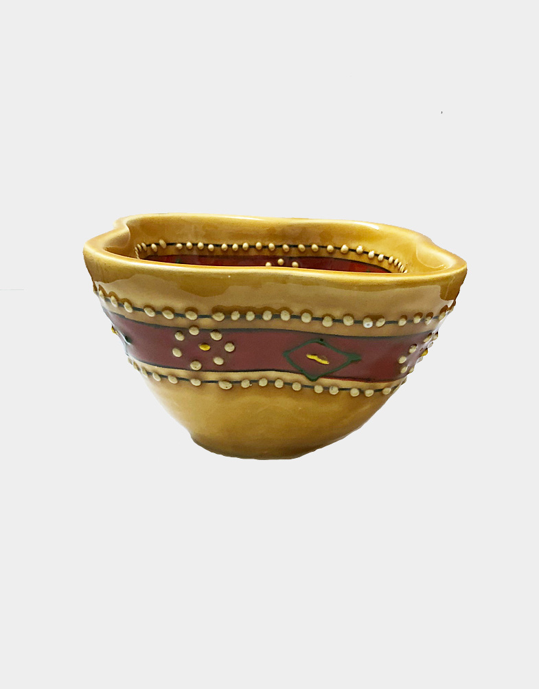 This richly-colored bowl is handcrafted and painted by Mexican artisans. A very functional pottery piece, it's beautifully decorated with a textured pattern. Shop now.