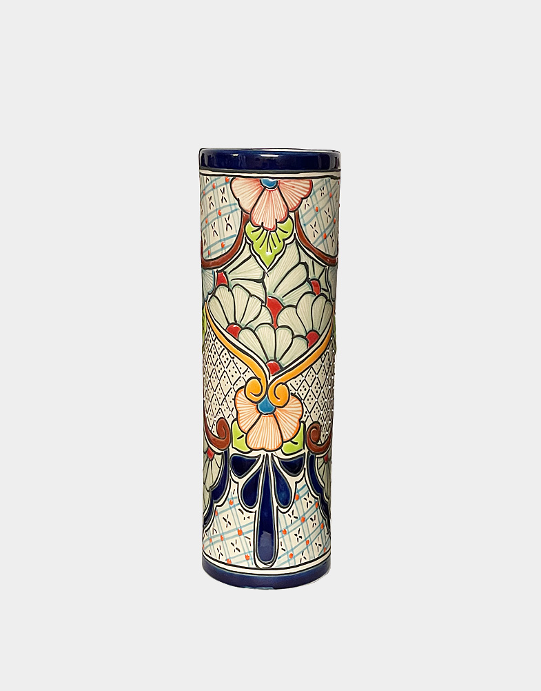 This ceramic vase features bold floral motifs glazed with bright red, blue, orange, and yellow. Connecting the flowers is a dot-filled trellis and bunting motif.