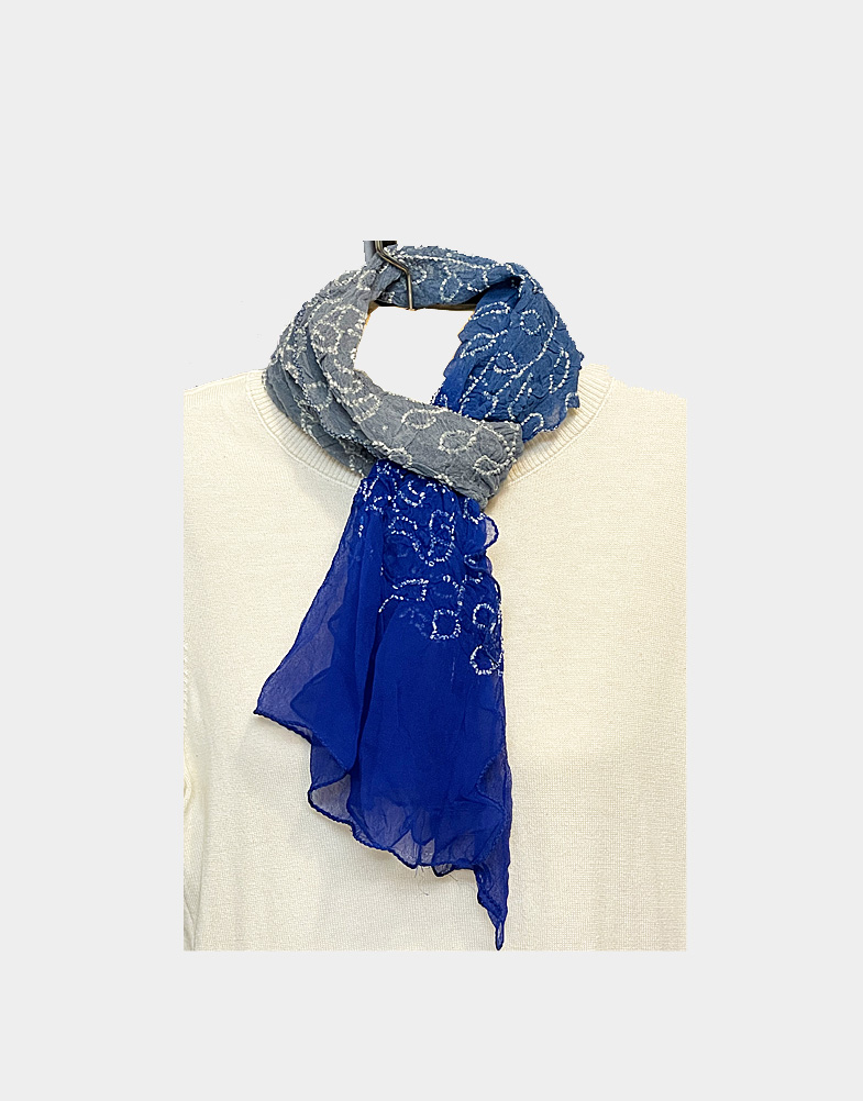This gorgeous feather weight georgette tie and dye fair trade scarf is made by women artisans in Western India features a beautiful shades of grey and royal blue.