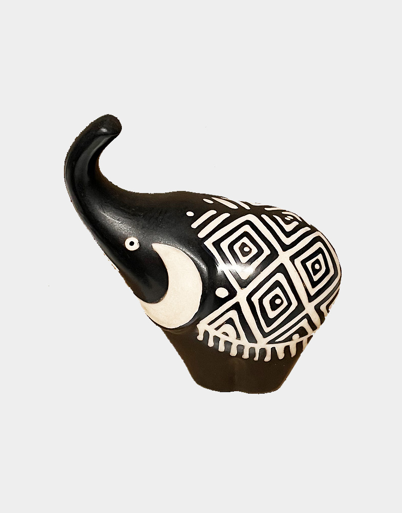 This fully handcrafted good luck trunk up elephant is made in black and creamy white color. This special pottery is made in Chulucanas town in Peru.