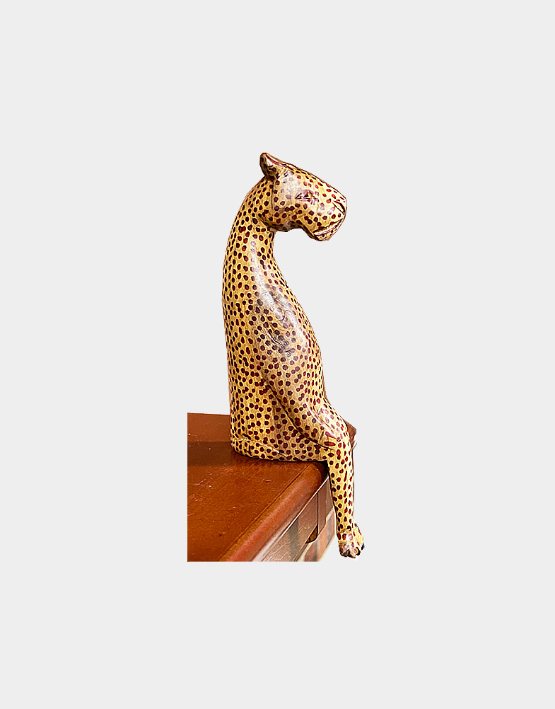 Decorate your book shelf with sitting animal sculptures, Each sculpture is carved to be perched on a ledge, and is brightened with hand painted stripes.
